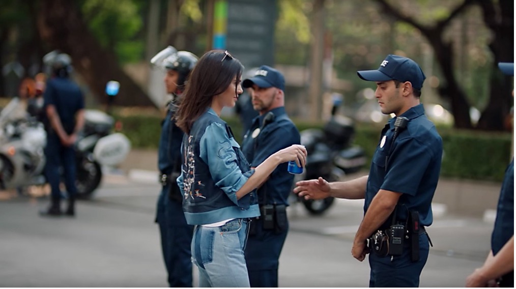 kendal jenner giving riot police a can of pepsi - controversial marketing campaign 